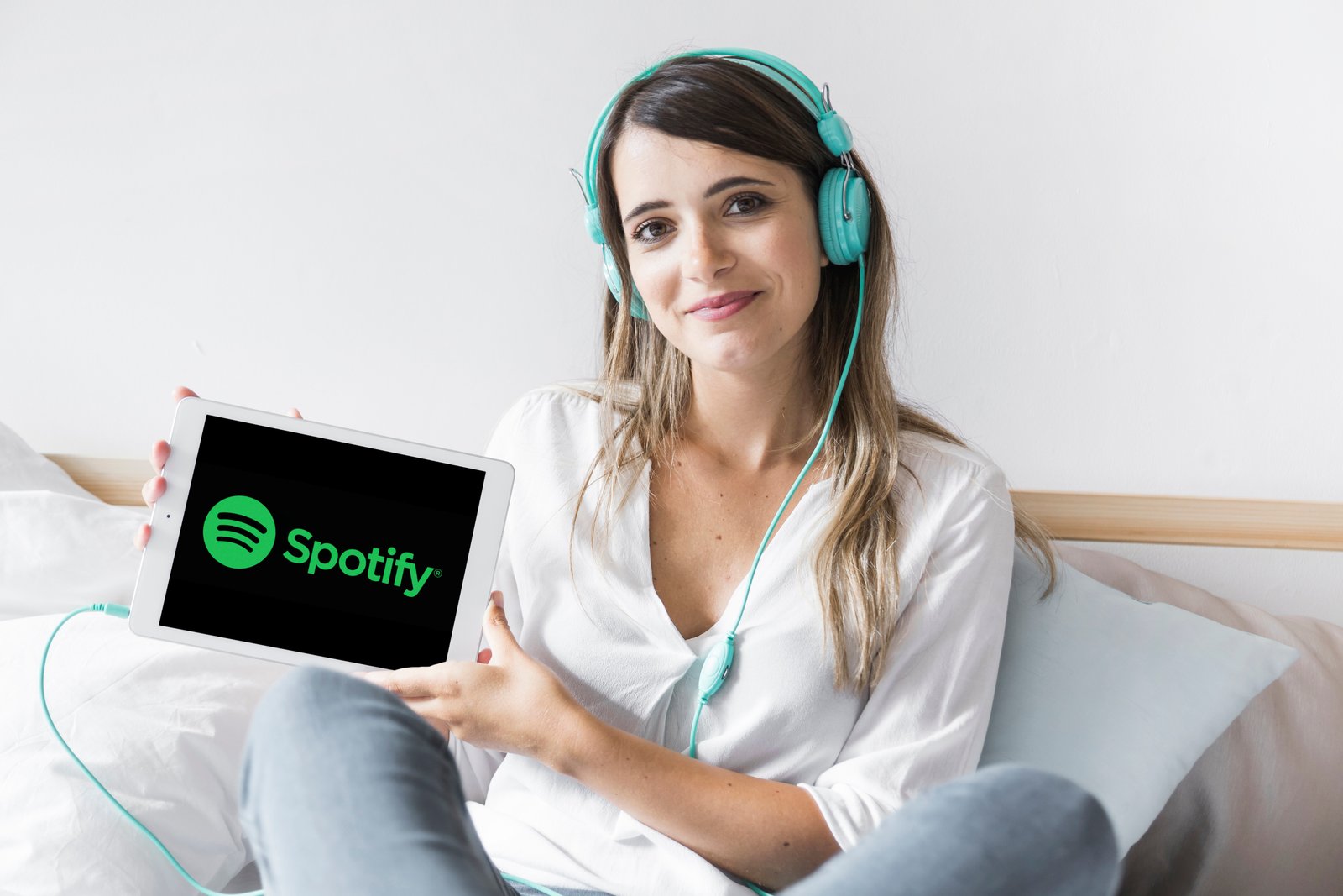 young woman holding tablet with spotify